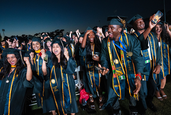 A group of students cheering at commencement last year