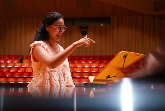A music alumna rehearses for an opera